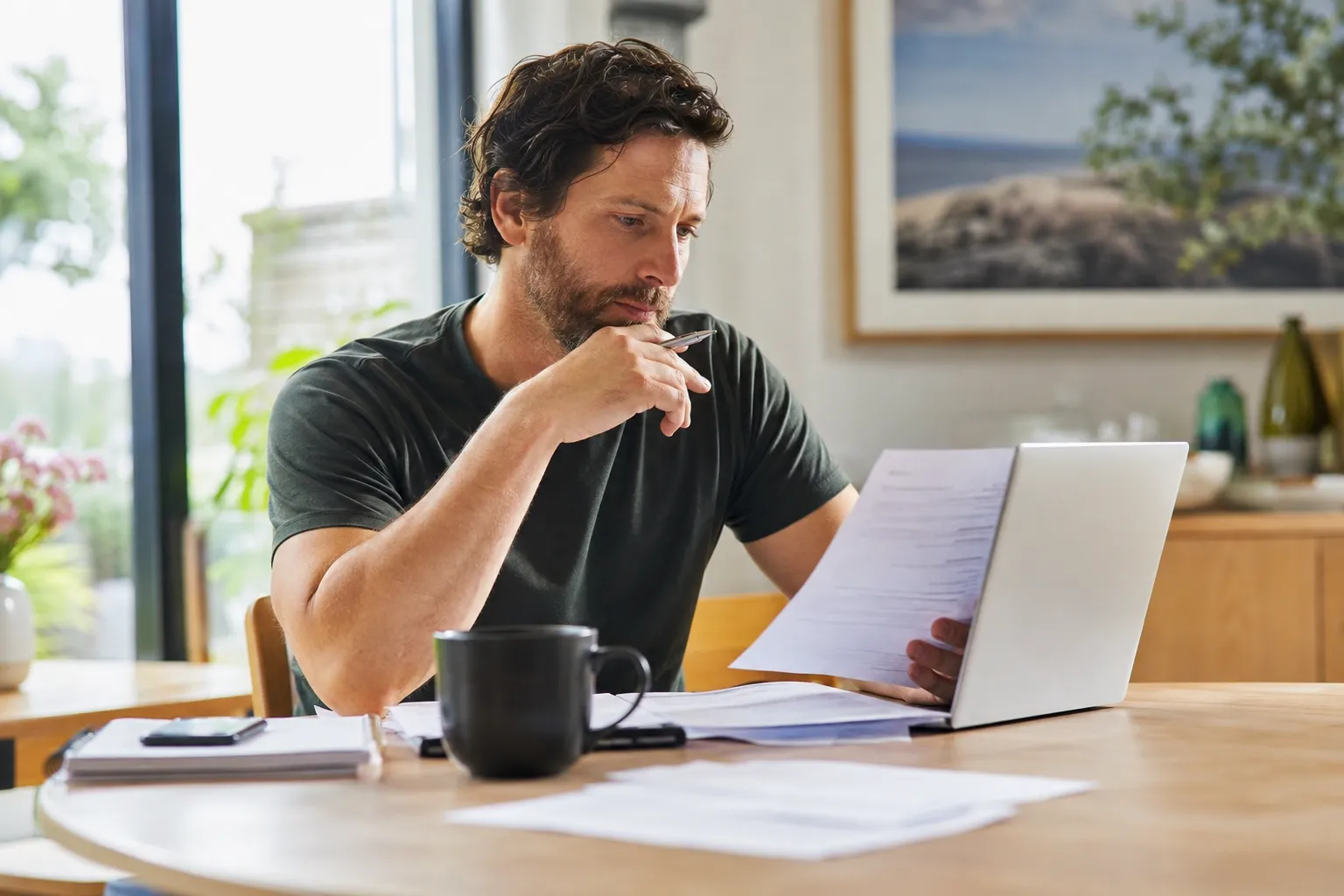 Australian adult reviewing health insurance policy information at home